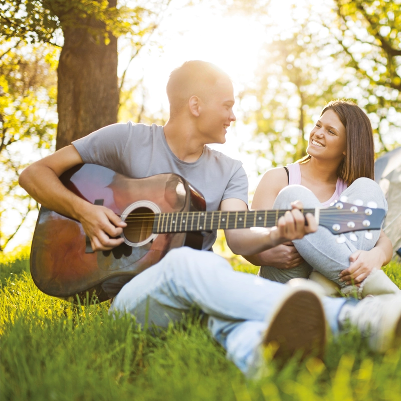 man-playing-guitar-outside-with-woman-800x800.webp