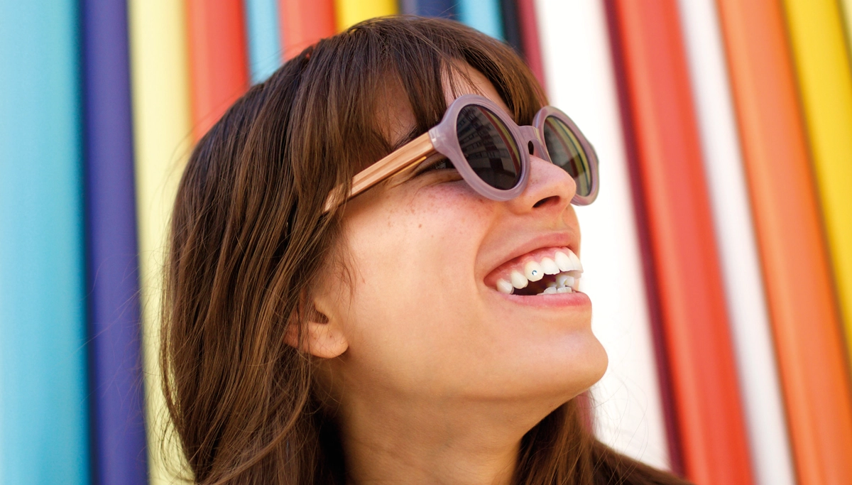 woman-with-tooth-gem-smiling-1200x683.webp